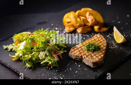 tuna steak with salad and spicy potatoes Stock Photo