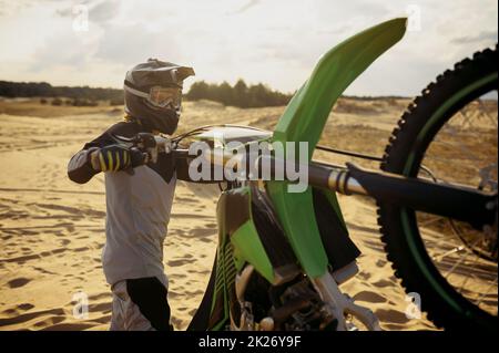 Extreme motocross rider riding on dirt track Stock Photo