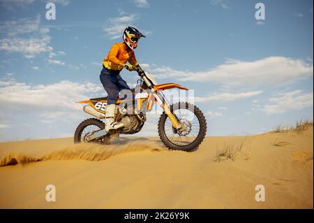 Professional speed rider driving in motocross race Stock Photo