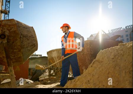 Male worker making concrete at construction site Stock Photo