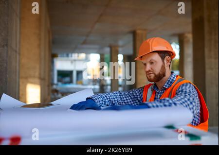 Contractor using digital tablet at construction site Stock Photo