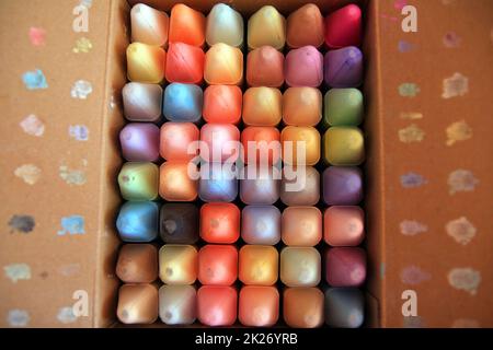 48 Colored crayons in a paper box with all the tips on the top Stock Photo