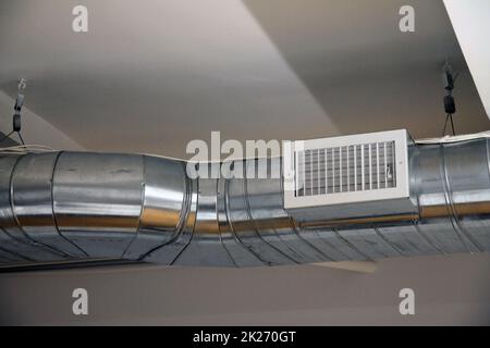Air conditioning and heating dispatching system on the ceiling of an industrial office Stock Photo