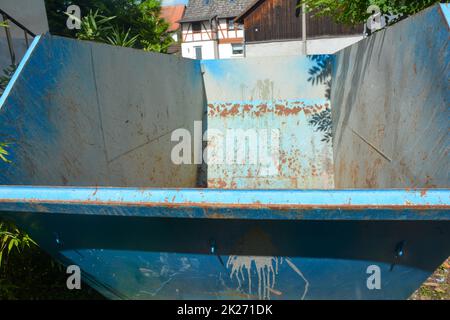 A empty waste container in a courtyard Stock Photo - Alamy