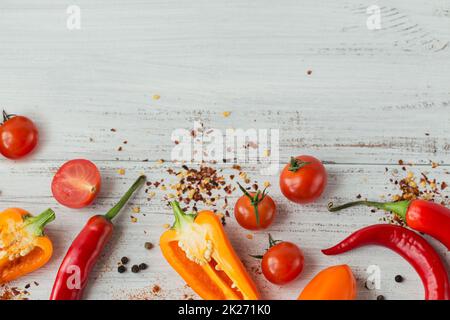 Assorted peppers, cherry tomatoes and spices on light background Stock Photo