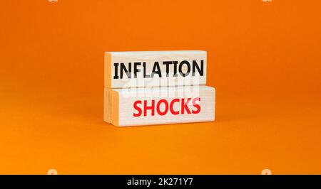 Inflation shocks symbol. Concept words Inflation shocks on wooden blocks. Beautiful orange table orange background. Business inflation shocks concept. Stock Photo