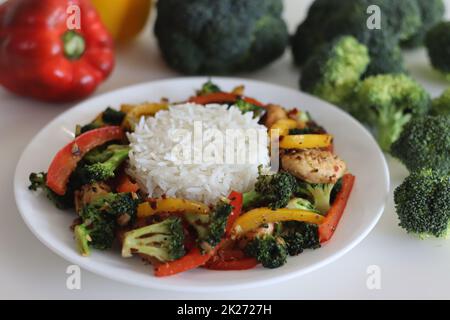 Stir fried vegetables with chicken. Air fried chicken tossed with sauteed bell peppers and broccoli. Served with boiled basmati rice. Shot along with Stock Photo