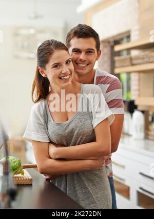 Times of tenderness. Portrait of an attractive young couple bonding in the kitchen. Stock Photo