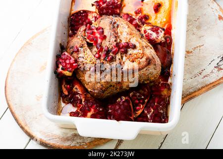 Pork loin in pomegranate marinade. Stock Photo