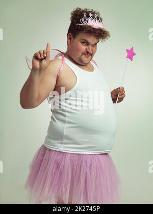 I've got something for you. Shot of an obese man wearing a fairy costume. Stock Photo