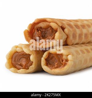 Wafer rolls with condensed milk isolated on white background Stock Photo