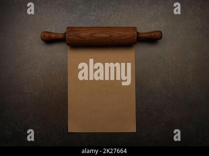 Vintage wooden rolling pin and brown paper Stock Photo