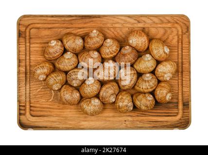 Two dozen of escargot snails on oak wood board Stock Photo