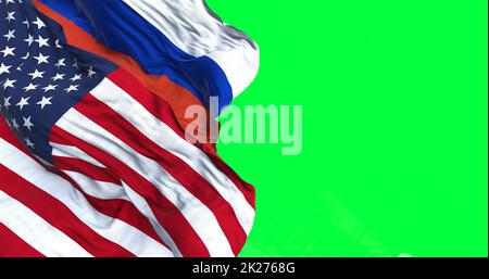 The flags of USA and Russia waving in the wind isolated over a green background Stock Photo