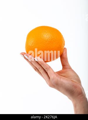 Woman hand holds fresh orange over white Stock Photo