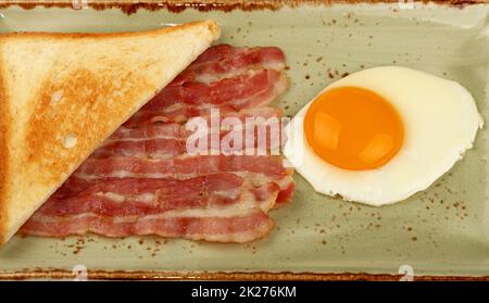 Close up egg, toast and bacon on plate Stock Photo