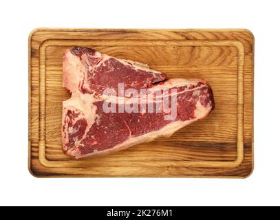 Close up raw beef T-bone steak on wooden board Stock Photo