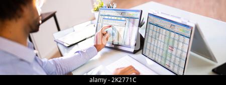 African American Analyst Using Spreadsheet Stock Photo