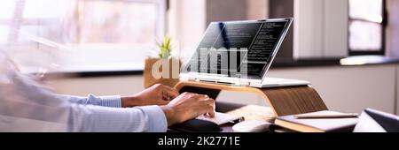African American Coder Using Computer At Desk Stock Photo