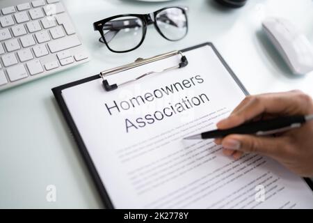 Person Reading HOA Rules Stock Photo