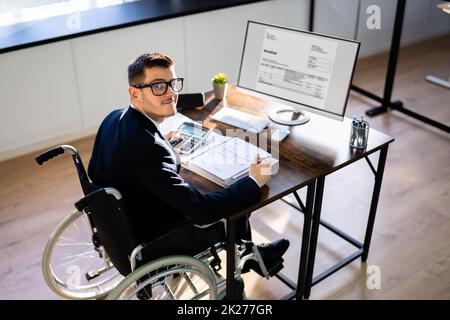 Accountant Using Tax Software In Office. Invoice Bill Stock Photo