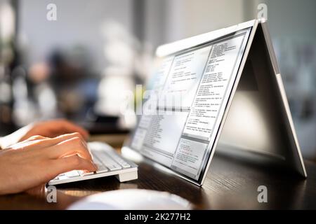 Programmer Or Coder At Office Desk Stock Photo