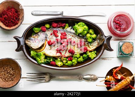 Appetizing gilthead fish in berry sauce. Stock Photo