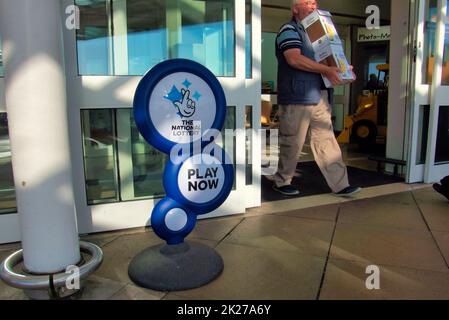 The national lottery advertising display stand play now in Glasgow, Scotland, UK Stock Photo