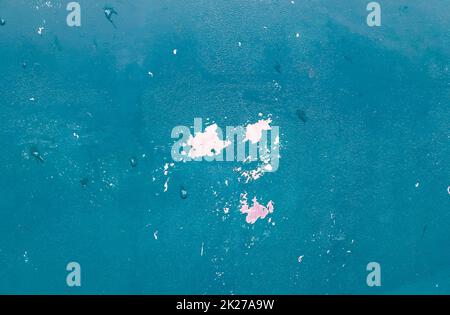 Detailed and colorful close up at cracked and peeling paint on concrete wall textures in high resolution Stock Photo