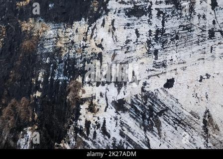 Detailed and colorful close up at cracked and peeling paint on concrete wall textures in high resolution Stock Photo