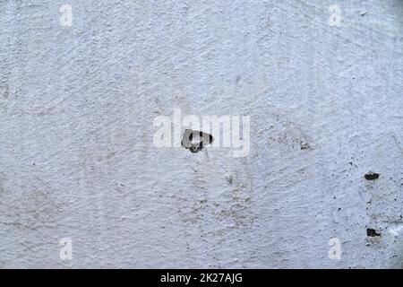 Detailed and colorful close up at cracked and peeling paint on concrete wall textures in high resolution Stock Photo