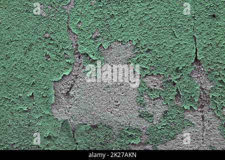 Detailed and colorful close up at cracked and peeling paint on concrete wall textures in high resolution Stock Photo