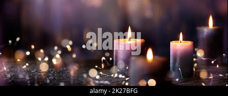 Advent Candles - Four Purple Votive Candlelight In Church With Defocused Abstract Lights Stock Photo