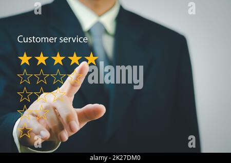 Businessman touching button to select five stars.Customer satisfaction and marketing survey rating concept Stock Photo