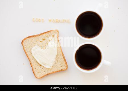 sandwich for breakfast in form of heart with cheese - good morning sign and two coffee cups Stock Photo