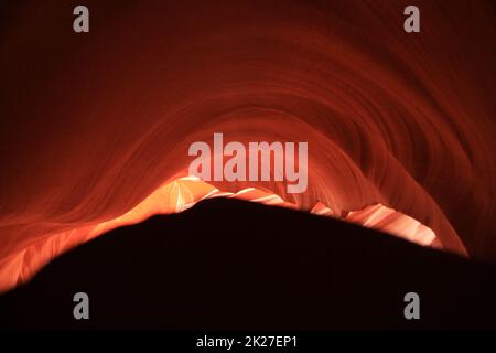 The abstract representation of the rising sun created by the nature of the red rocks of the Antelope Canyon Stock Photo