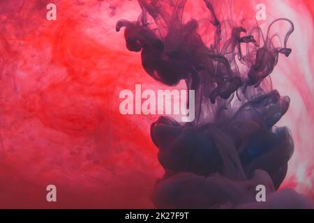 Paint in the water abstract background. ink in fluid. colorful splashes in liquid. red and blue colors Stock Photo