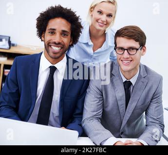 Powerful team of diverse minds. Portrait of three colleagues smiling at the camera. Stock Photo