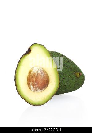 Avocado cut half isolated against white background - macro shot Stock Photo