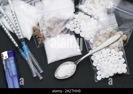 cooked heroin drugs and injection syringe on black background Stock Photo