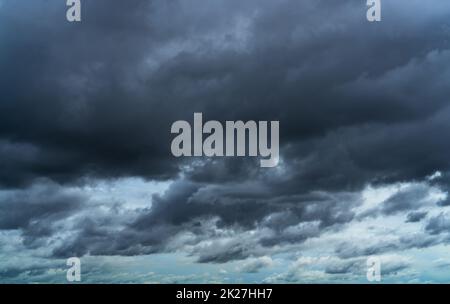 Overcast sky. Dramatic gray sky and dark clouds before rain in rainy season. Cloudy and moody sky. Storm sky. Gloomy and moody background. Overcast clouds. Sad, lonely, and death abstract background. Stock Photo