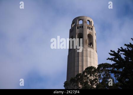 The top of the emblematic Coit tower with clouds behind in San Francisco Stock Photo