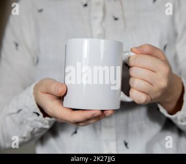 Girl holding blank white coffee mug , white porcelain mug mock up, coffee, tea, milk or soda, copy space Stock Photo