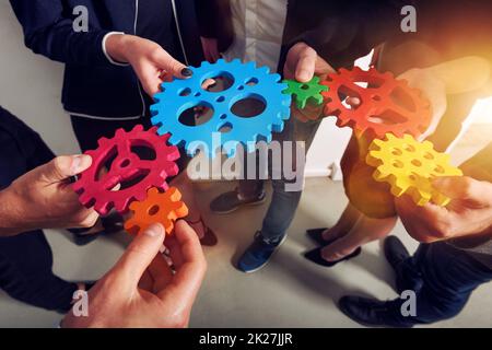 Business team connect pieces of gears as teamwork and partner Stock Photo