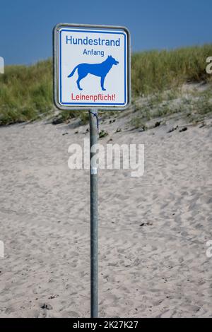 On the beach, dog beach on the Baltic Sea, there is a sign marking the area of â€‹â€‹the dog beach. Stock Photo