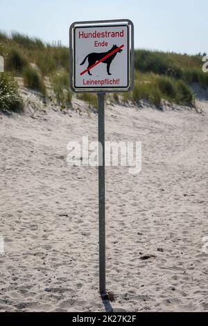 On the beach, dog beach on the Baltic Sea, there is a sign marking the area of â€‹â€‹the dog beach. Stock Photo