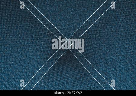 Dark blue denim background with white stitching close up Stock Photo