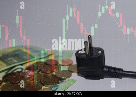 energy consumption and increase in electricity prices euro bills and coins with a chart in the background Stock Photo