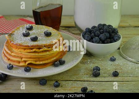 Pancakes with blueberries, maple syrup on a rustic white background Stock Photo