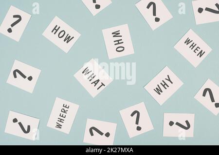 The words who what where how why and when are standing on small pieces of paper, question marks, asking for solution, problem solving Stock Photo